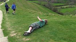 The youngsters take it in turns to roll down the hill from the top of Glastonbury Tor
